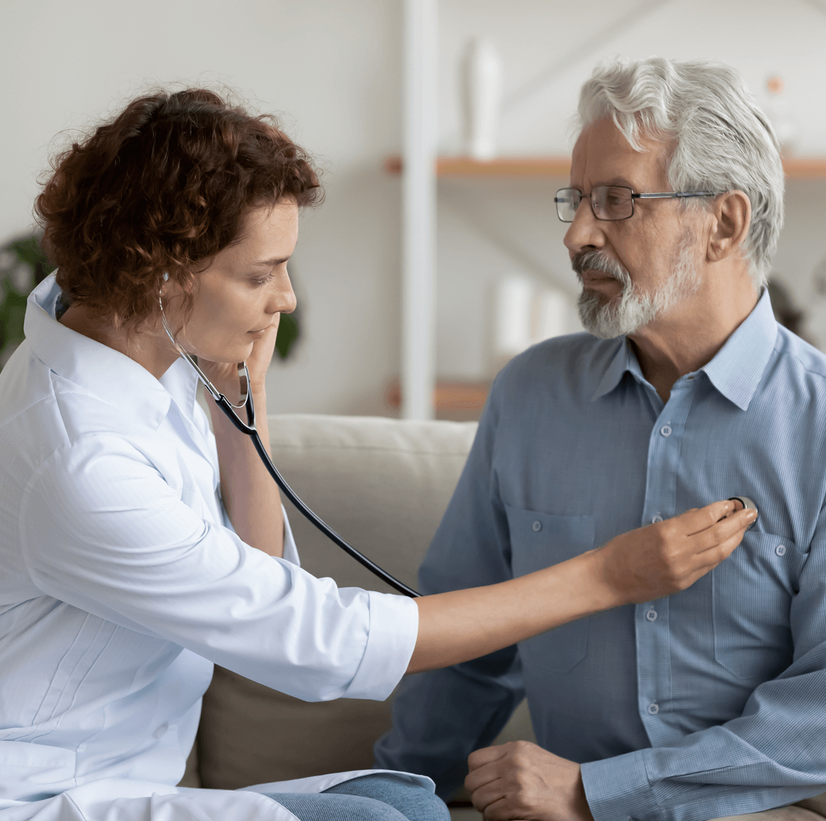 Doctor using stethoscope on older man